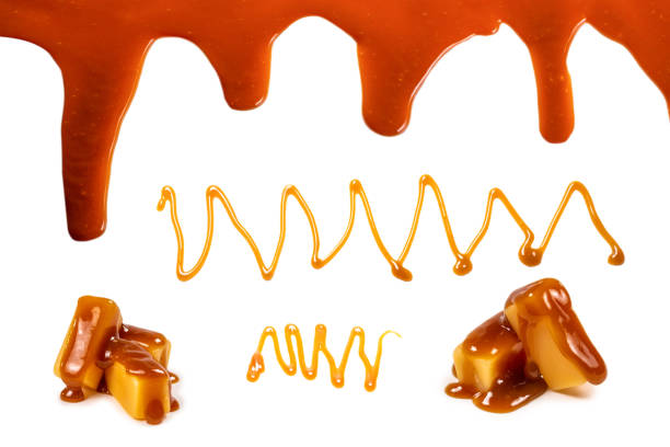istock Background of flowing caramel sauce isolated on white. 1309581448