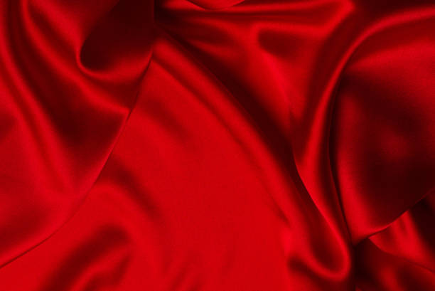istock Red silk or satin luxury fabric texture can use as abstract background. 1309581460