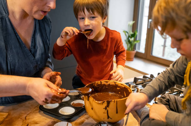 istock Kids helping their mother make muffins 1309581638