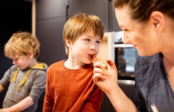 istock Kids helping their mother make muffins 1309582361
