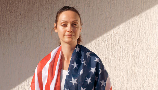istock American woman under American flag 1309584329
