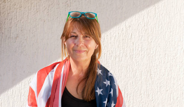 istock Middle aged woman with American flag 1309584355