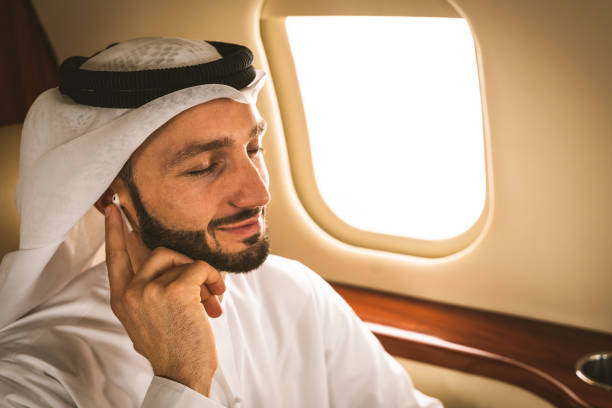 istock Arabian man wearing kandora flying on private jet 1309585842