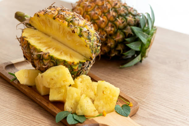 istock Fresh sliced pineapple on wooden tray on table. 1309586859