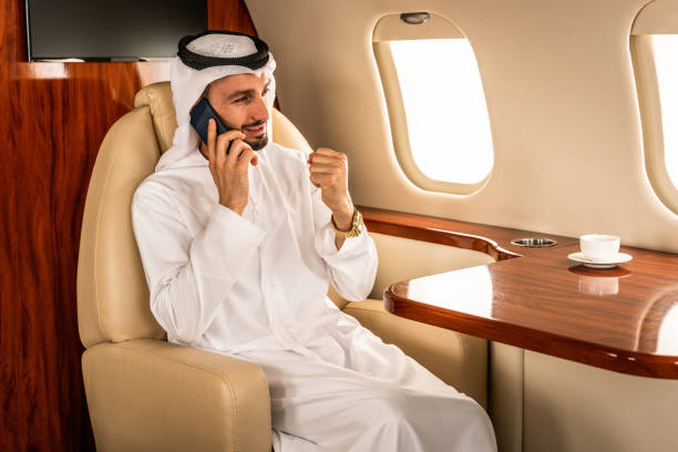 istock Arabian man wearing kandora flying on private jet 1309587971