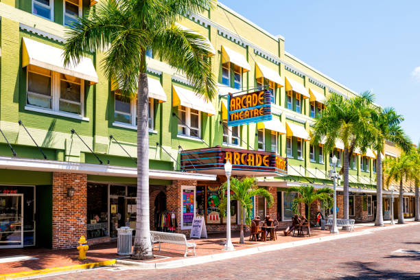 Florida Gulf of Mexico city street with retro vintage neon sign for Arcade theatre theater building with shops stores Fort Myers, USA - April 29, 2018: Florida Gulf of Mexico city street with retro vintage neon sign for Arcade theatre theater building with shops stores fort myers stock pictures, royalty-free photos & images