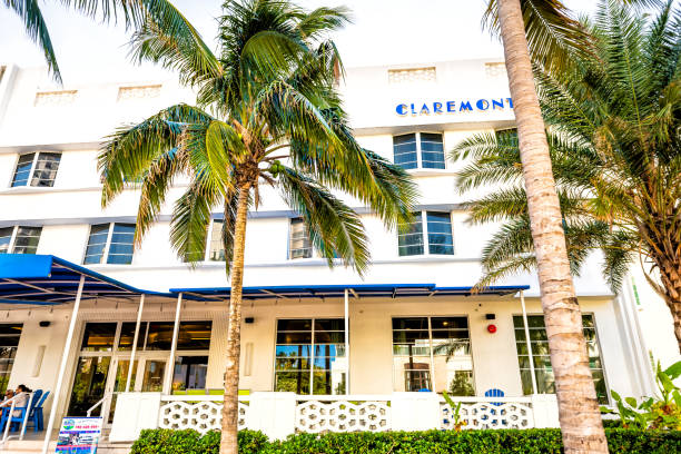 Florida Art Deco Claremont Hotel in South Beach with people eating at sidewalk outdoor cafe restaurant at Ocean Drive district Miami Beach, USA - May 5, 2018: Florida Art Deco Claremont Hotel in South Beach with people eating at sidewalk outdoor cafe restaurant at Ocean Drive district claremont showgrounds stock pictures, royalty-free photos & images