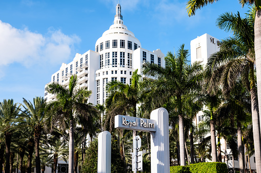 Miami Beach, USA - May 5, 2018: Royal Palm South Beach spa resort hotel in Florida with entrance sign by palm trees in Art Deco district on Collins avenue in summer