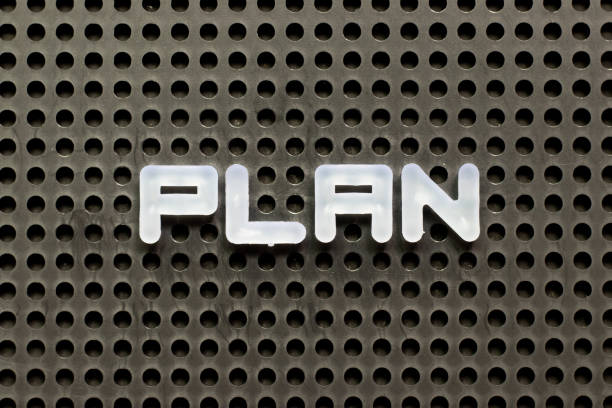 istock White color letter in word plan on black pegboard background 1309592565