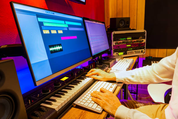 istock producer, arranger, composer hands playing keyboard for recording midi track on digital audio workstation computer in recording studio. music production concept 1309594716
