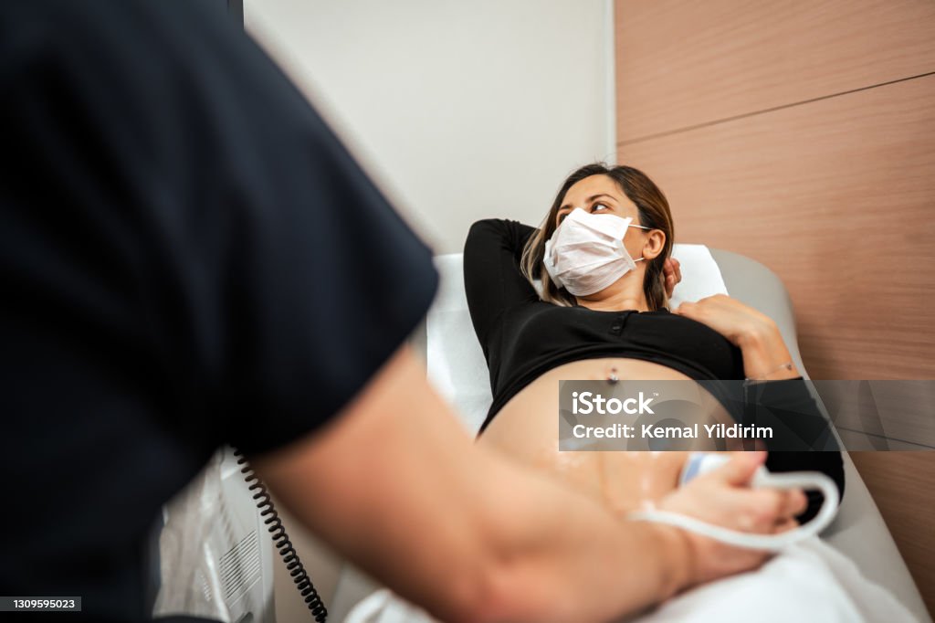 Pregnant woman watching her baby on the ultrasound Pregnant Stock Photo