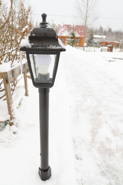 istock Outdoor black lantern in the yard in winter 1309599389