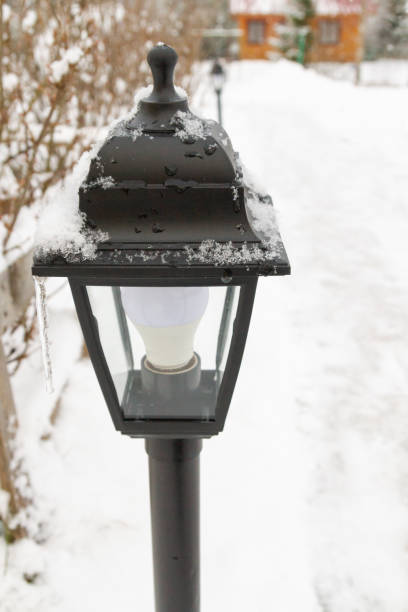 istock Outdoor black lantern in the yard in winter 1309599400