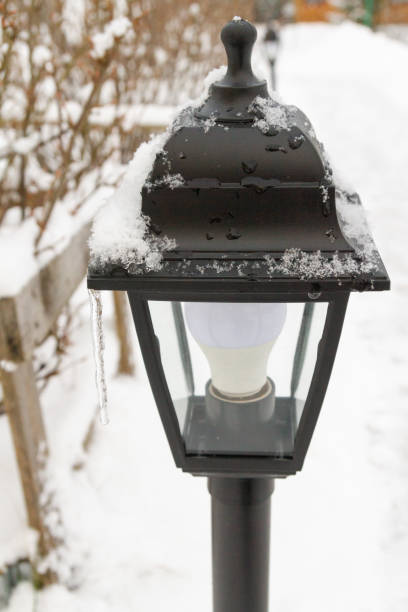istock Outdoor black lantern in the yard in winter 1309599540