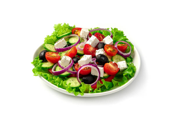 istock White plate with fresh Greek salad isolated on a white background 1309600535