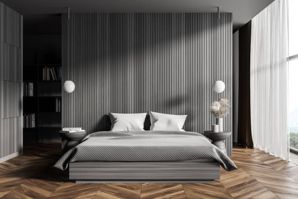 istock Dark wooden master bedroom interior with bookcase 1309600735