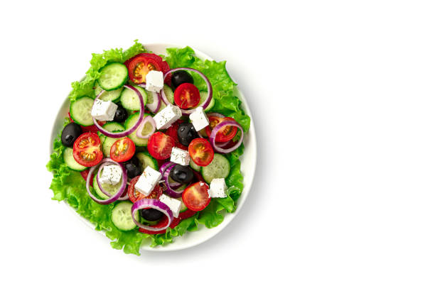 istock Fresh vegetable salad with olives, and cheese isolated on a white background 1309600764