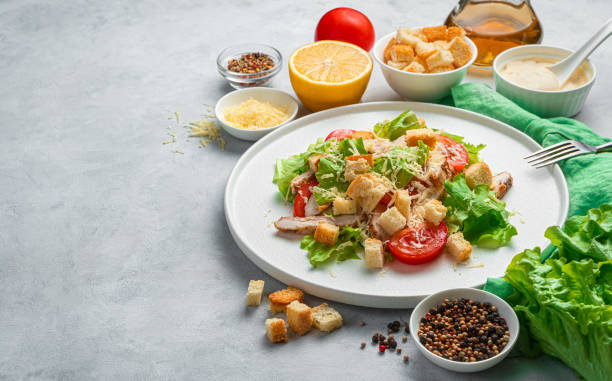 istock Caesar salad with croutons on a gray background 1309602217