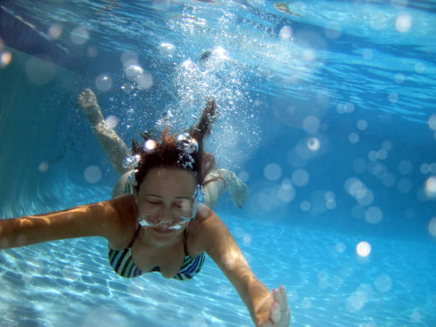 istock Woman swimming underwater 1309602269