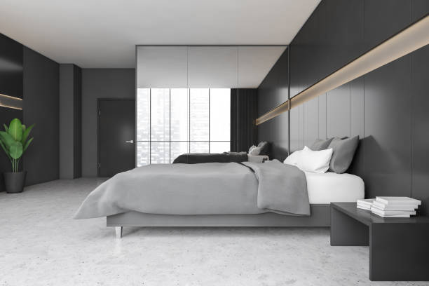 istock Black and grey bedroom with bed and linens, wardrobe and window 1309602920