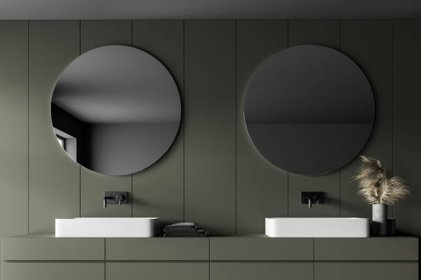 istock Grey and green bathroom with two sinks and mirrors 1309603087