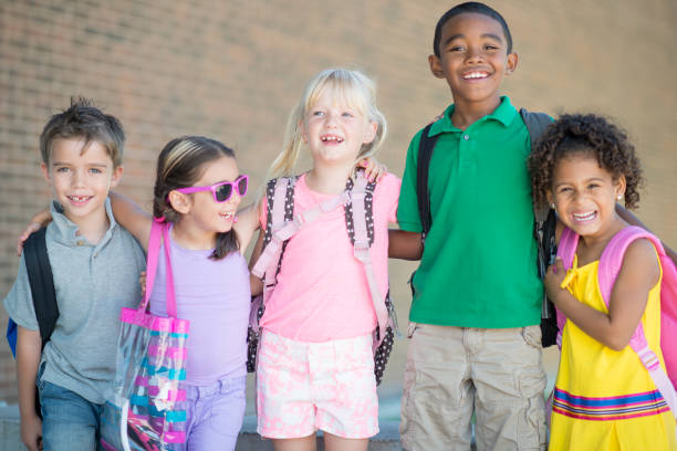 istock Multi ethnic group of elementary school children smiling at the camera 1309605183