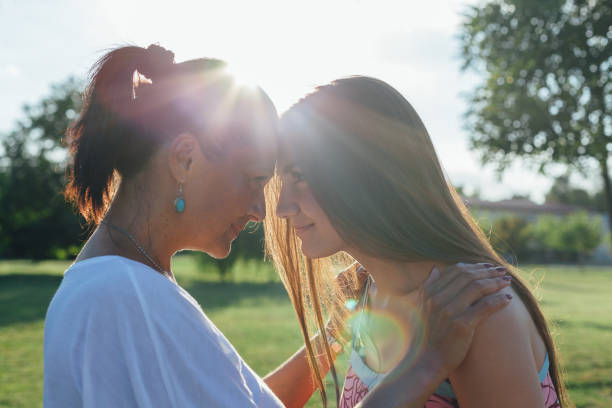 istock Daughter With Mother Hugging At Sunset 1309606066