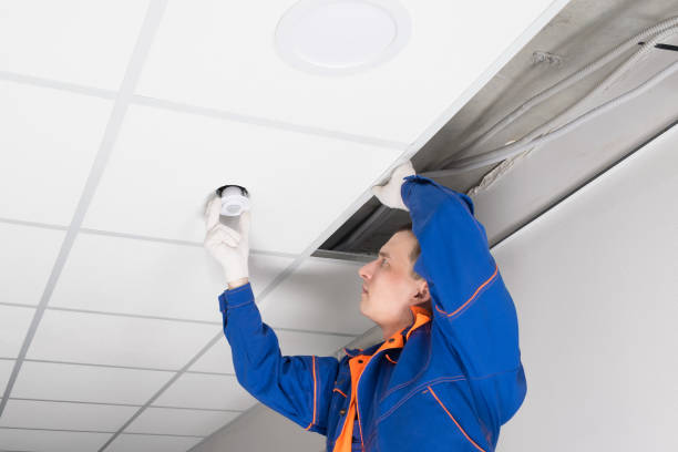 istock a worker adjusts the luminaire in the false ceiling 1309606744