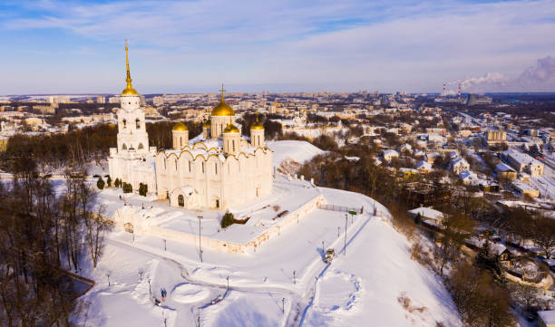 Aerial view of snow covered Orthodox Dormition Cathedral in Vladimir Scenic aerial view of snow covered architectural ensemble of Orthodox Dormition Cathedral in Russian town of Vladimir in winter vladimir russia photos stock pictures, royalty-free photos & images