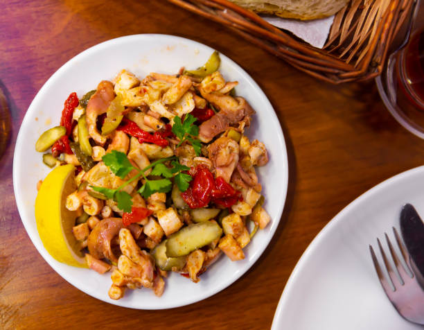 istock Delicious octopus salad with parsley and lemon 1309607534