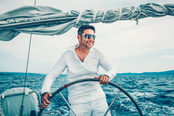 istock Man sailing with sailboat 1309608868