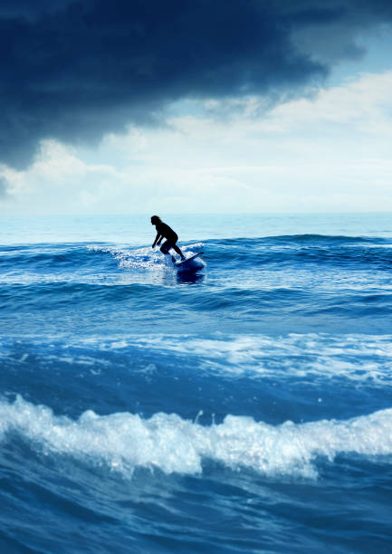 istock Young man surfing over stormy sky 1309611624