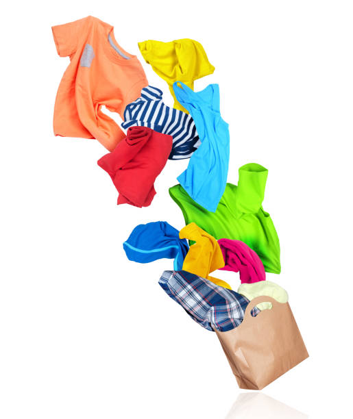 istock Bright colorful clothes flying out from paper package isolated on white background 1309611739