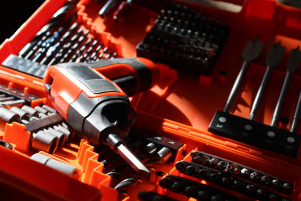 istock Set of tools in an orange case including a power screwdriver, driver bits, spade bits, and drill bits 1309612118