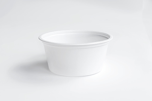 White plastic cup disposable catchup bowl isolated on white background. Front view, mockup