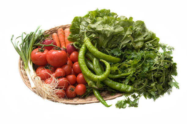 Close up bowl of various fresh vegetables over white