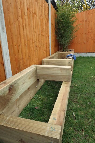 istock Wooden flower or raised beds under construction from railway sleepers 1309613688