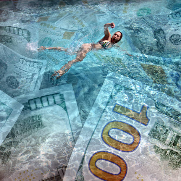Business prosperity concept conceptual finance image of one person swimming on clear blue water full with American one hundred dollar bills women exercising swimming pool young women stock pictures, royalty-free photos & images