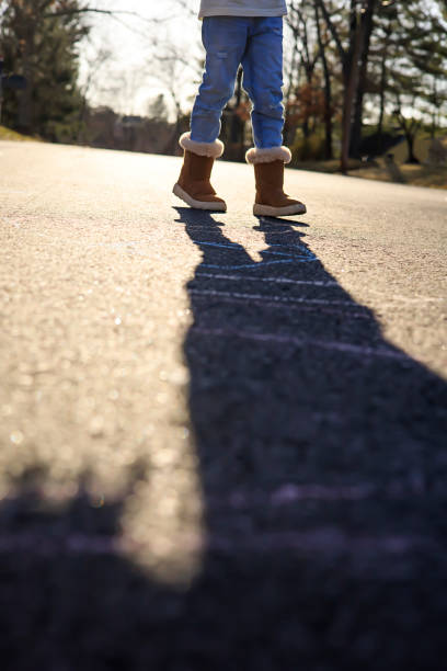 istock Boots and a shadow on the street 1309614654