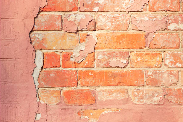 istock red brick wall behind pink plaster, old building wall 1309614678