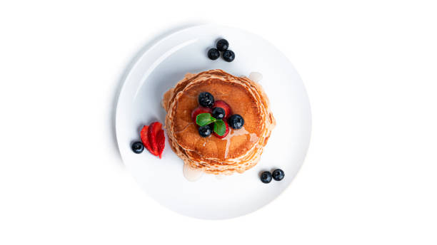 istock Pancakes with berries isolated on a white background 1309615758