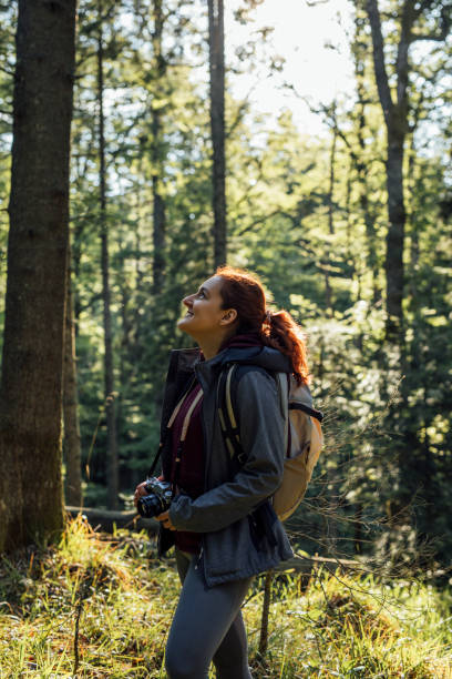 istock Happy Hiker with Camera Enjoying the Walk in the Woods 1309618685