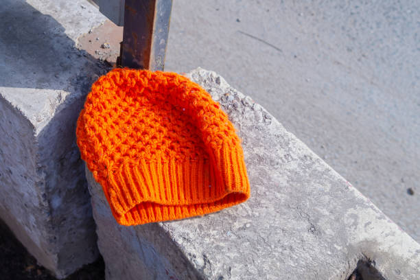 istock A lost orange women's sequinned hat lies on a concrete block 1309619659