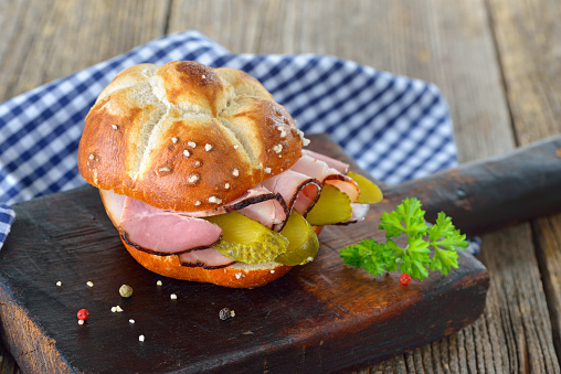 Bavarian lye roll sandwich with smoked country ham and sliced pickles