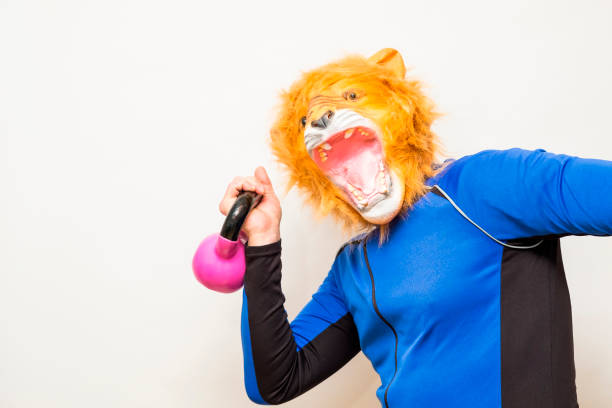 Man in a lion's mask lifting a Russian weight