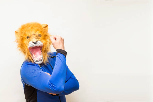 istock Man in a lion mask showing off his muscle 1309624576