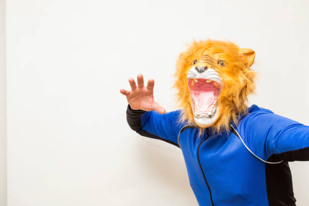 istock Man with lion mask ready to attack 1309624582