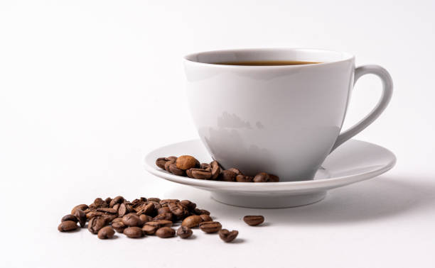 istock Black coffee in a white cup and coffee beans isolated on white background. 1309625758