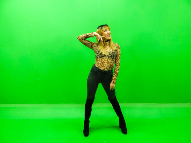 istock Woman posing with green background 1309625869