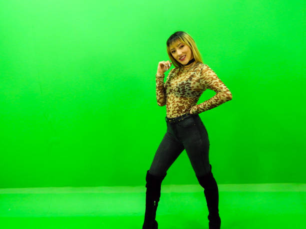 istock Woman posing with green background 1309625872